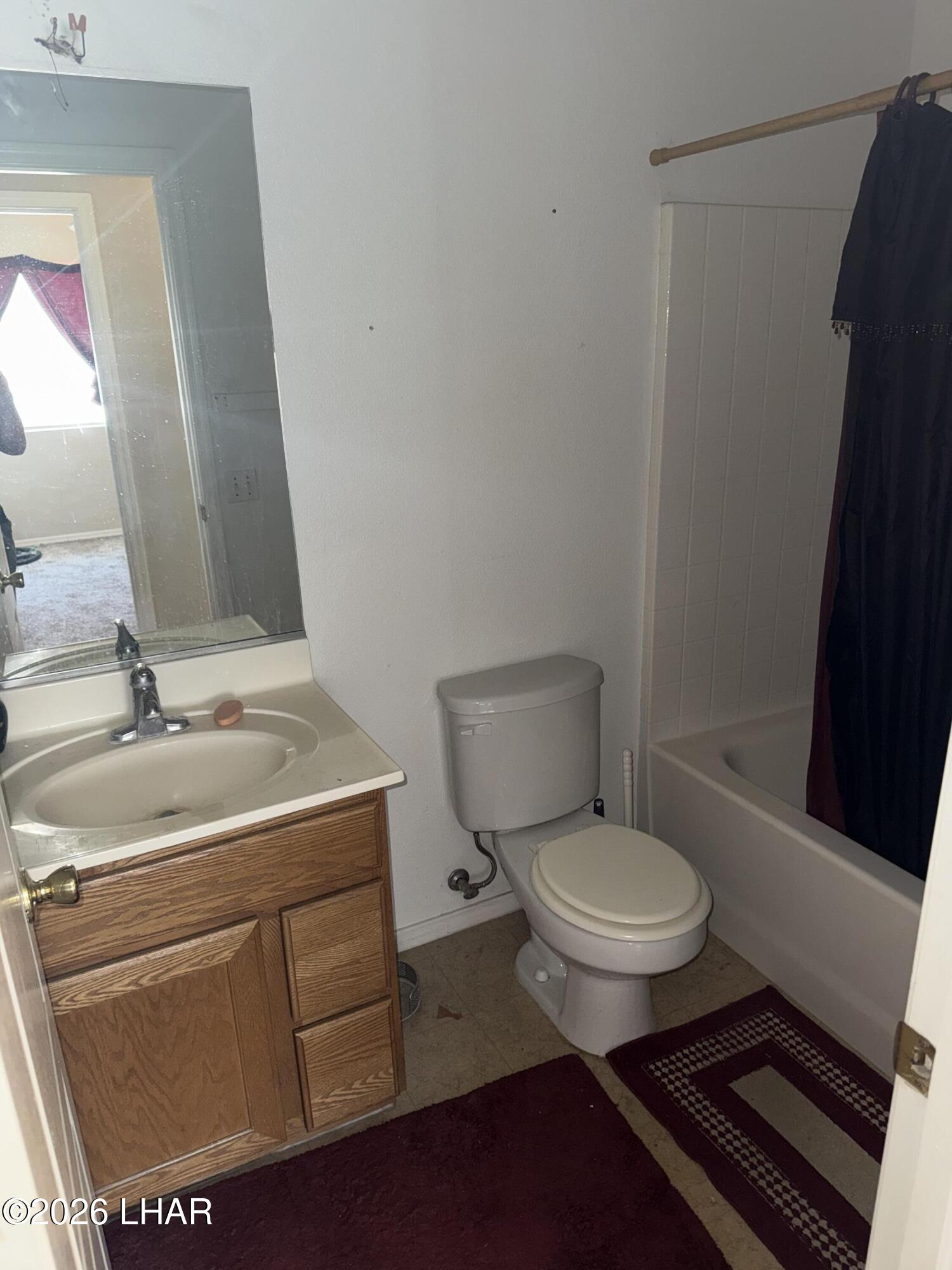 4897 South Rinaldi Drive Fort Mohave, AZ 86426 - Photo 12 of 22 a bathroom with a toilet sink and mirror