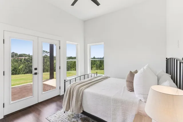 a bedroom with a bed and glass door