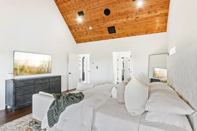 a bedroom with a bed and a flat screen tv