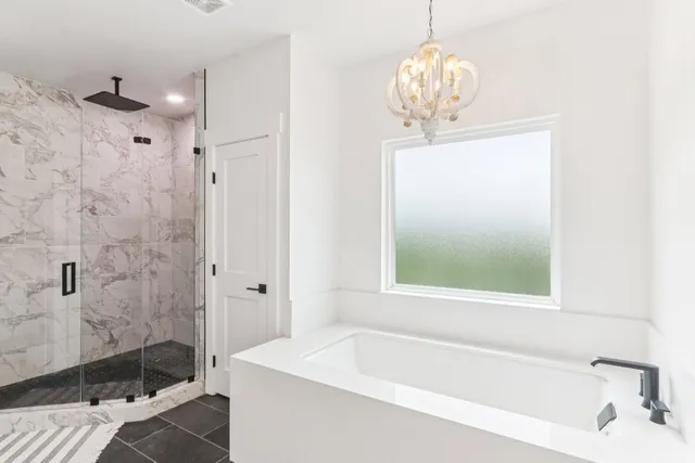 a bathroom with a tub sink and shower