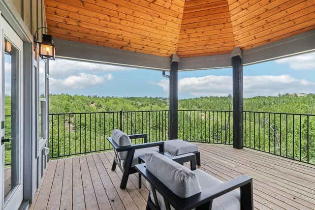 a view of a balcony with lake view and wooden floor