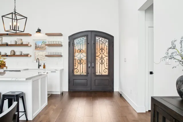 a view of kitchen with stainless steel appliances granite countertop a stove a sink and a refrigerator with wooden floor