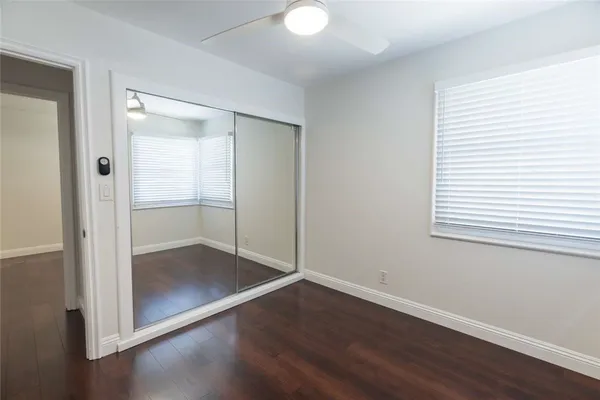an empty room with wooden floor and door