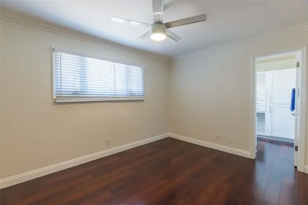 a view of a room with wooden floor and windows