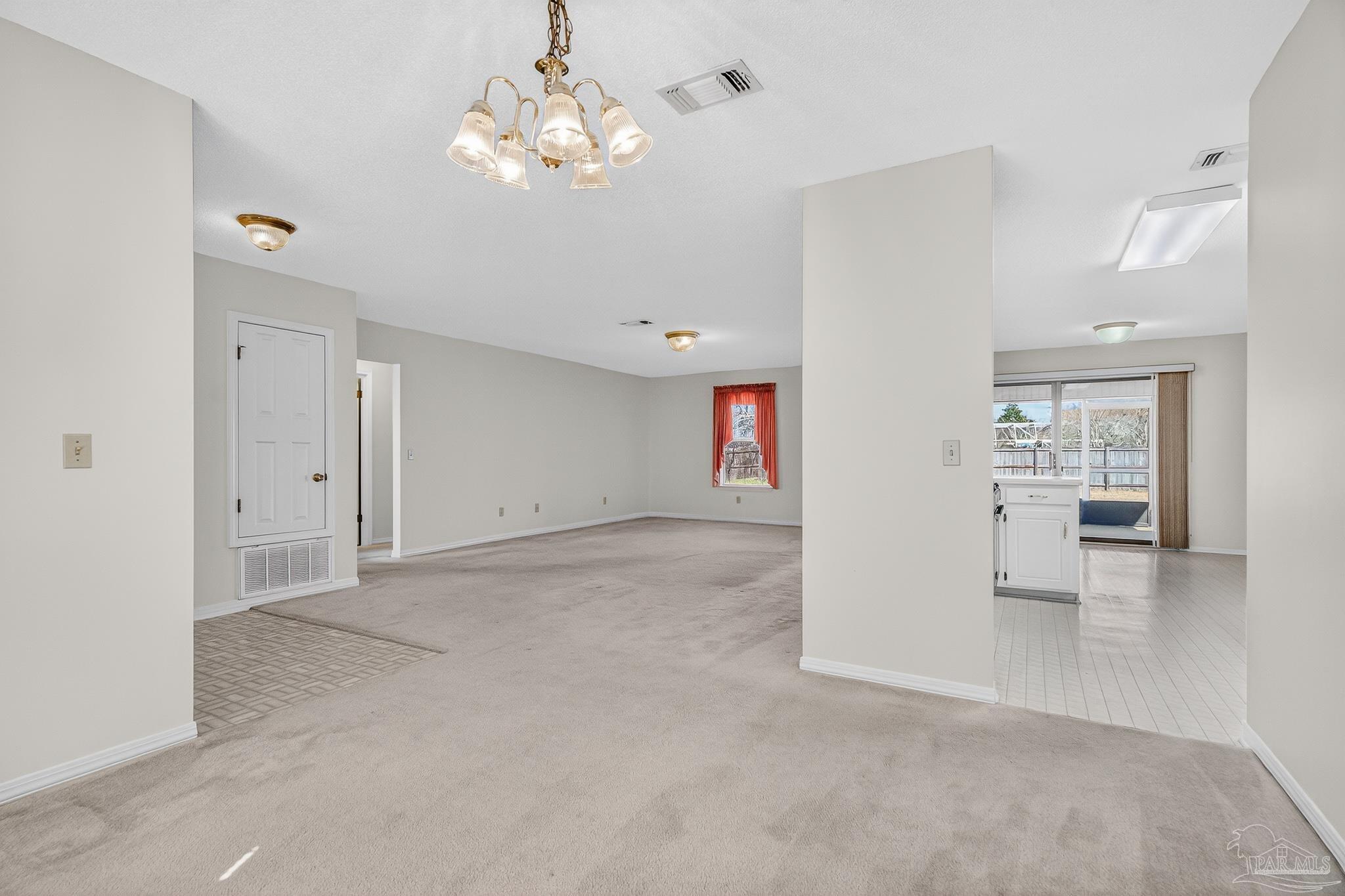 2236 Cricket Ridge Drive Cantonment, FL 32533 - Photo 13 of 57 an empty room with chandelier and glass door
