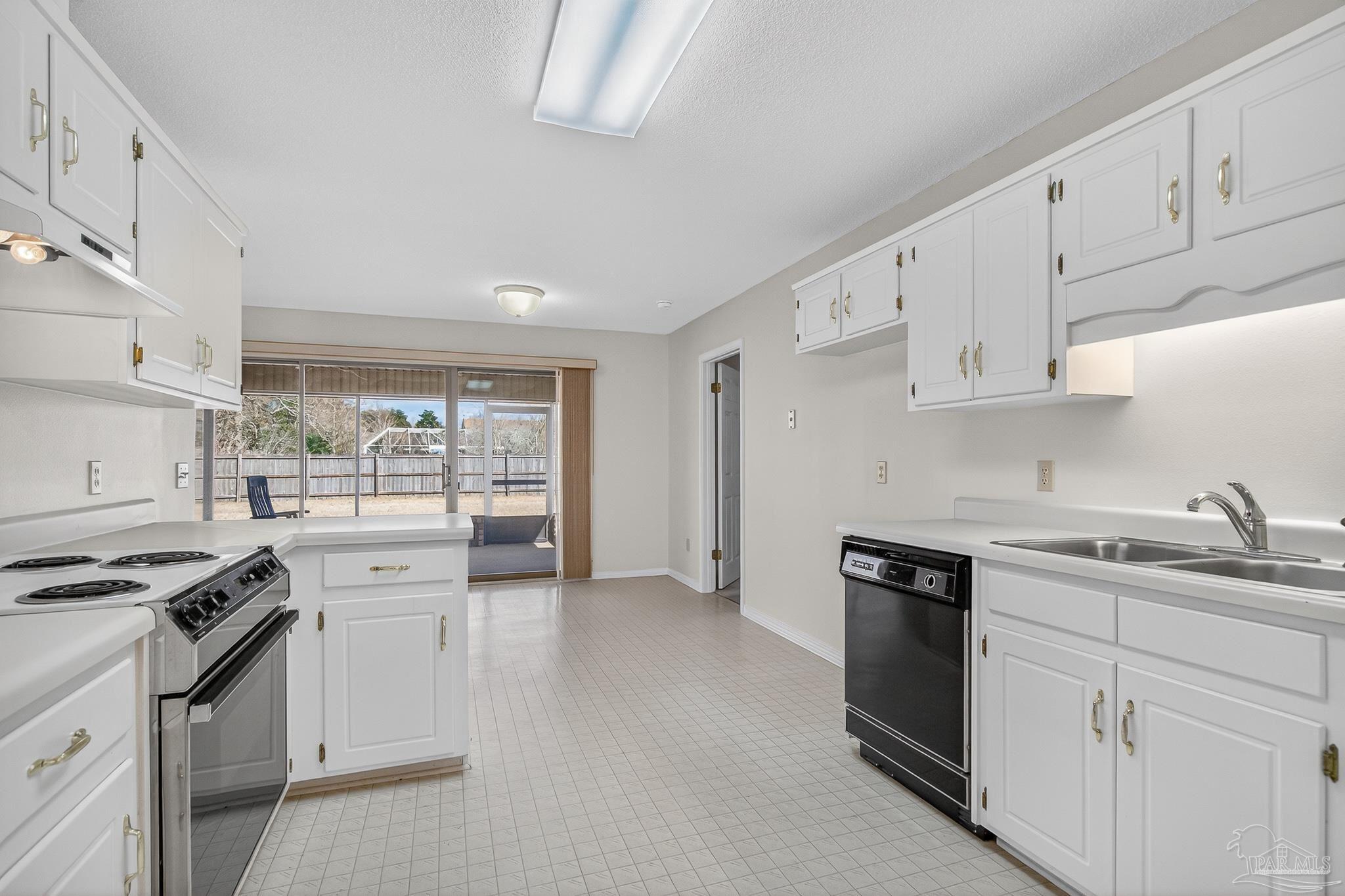 2236 Cricket Ridge Drive Cantonment, FL 32533 - Photo 17 of 57 a kitchen with granite countertop a sink stove and cabinets