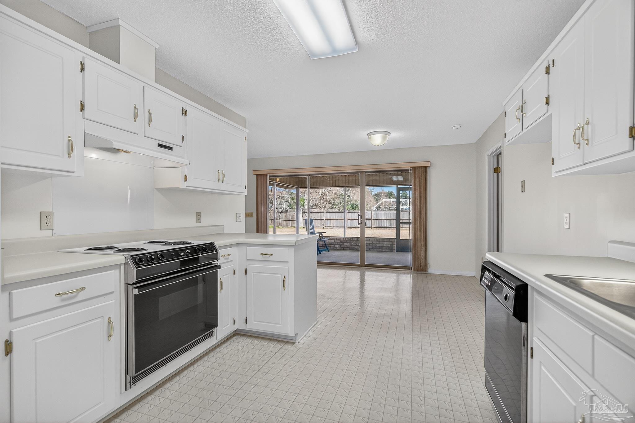 2236 Cricket Ridge Drive Cantonment, FL 32533 - Photo 18 of 57 a kitchen with white cabinets and appliances