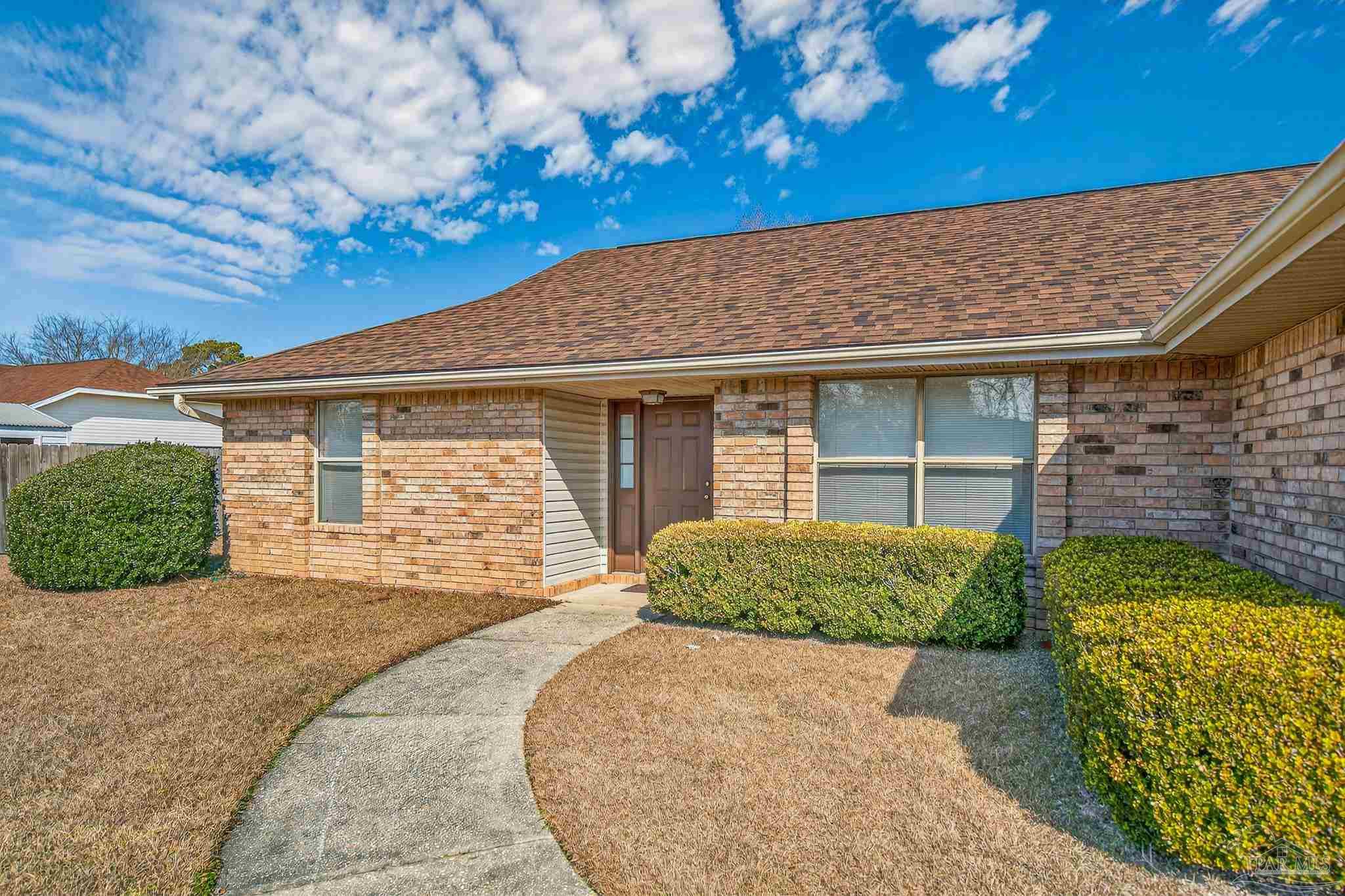 2236 Cricket Ridge Drive Cantonment, FL 32533 - Photo 3 of 57 a front view of a house with garden