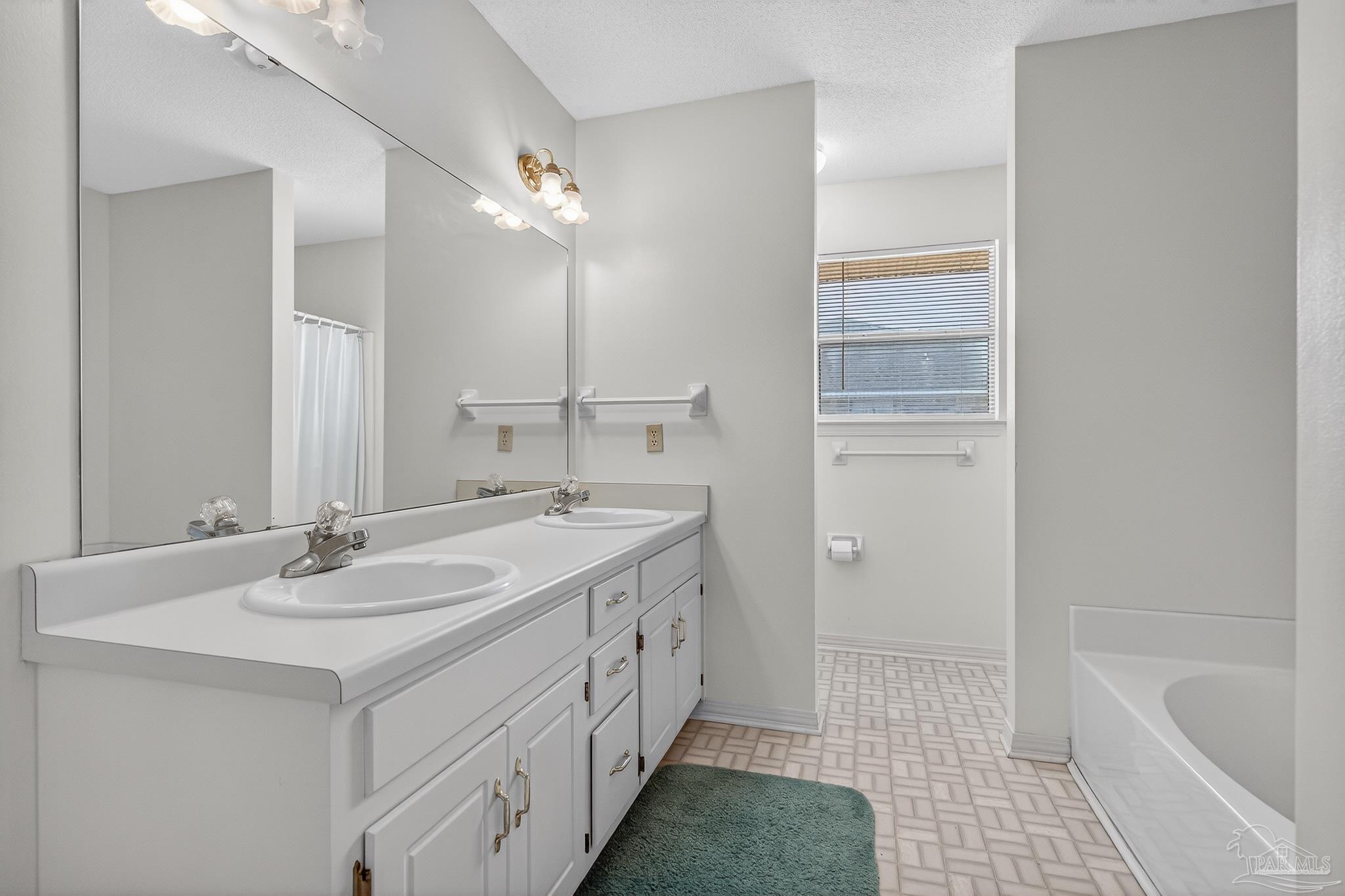 2236 Cricket Ridge Drive Cantonment, FL 32533 - Photo 32 of 57 a bathroom with a tub sink and mirror