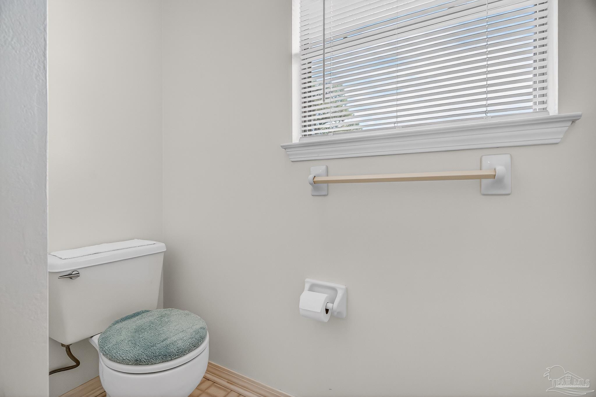 2236 Cricket Ridge Drive Cantonment, FL 32533 - Photo 37 of 57 a white toilet sitting in a bathroom next to a window