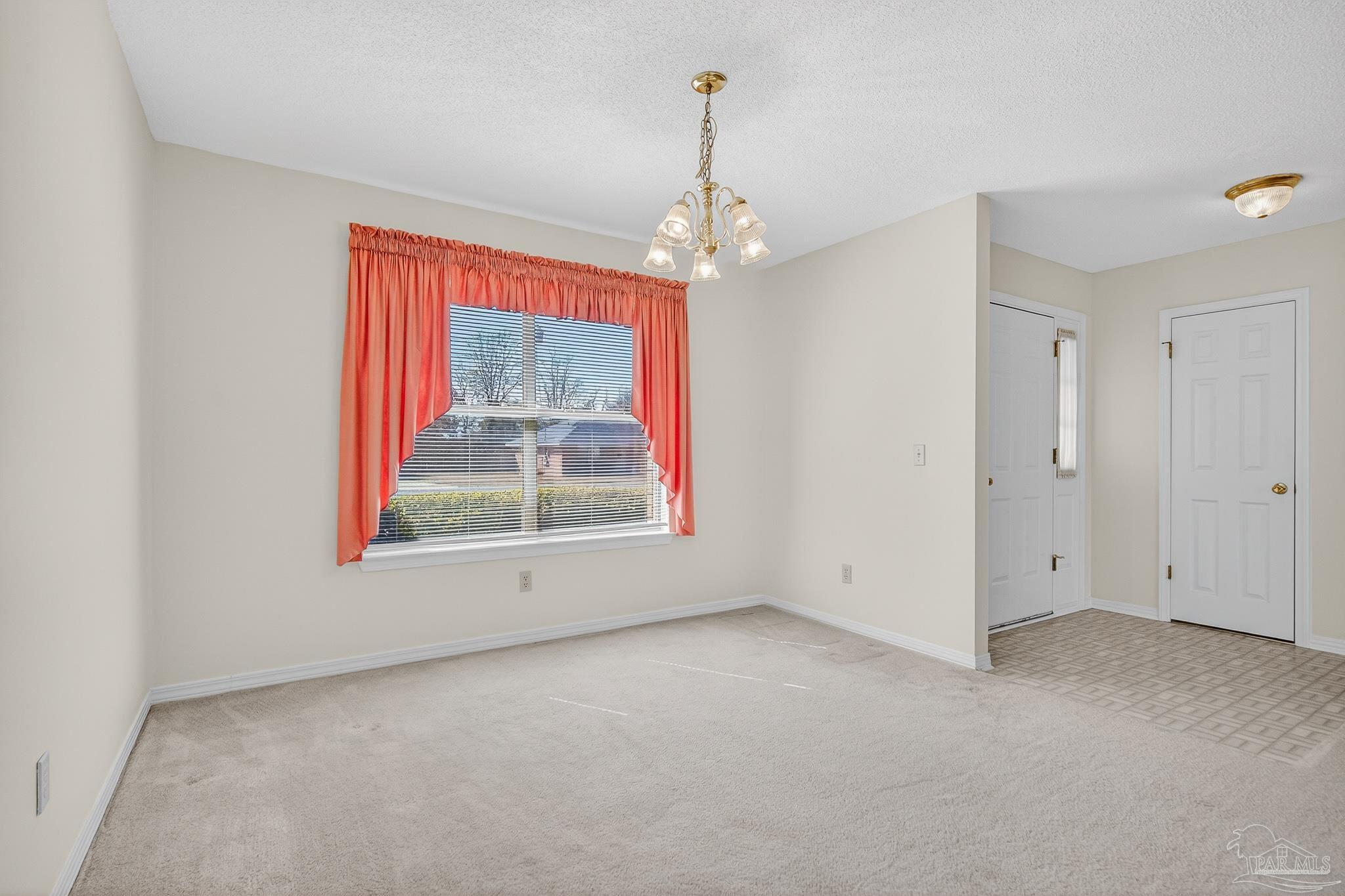 2236 Cricket Ridge Drive Cantonment, FL 32533 - Photo 9 of 57 en empty room with windows and outdoor view