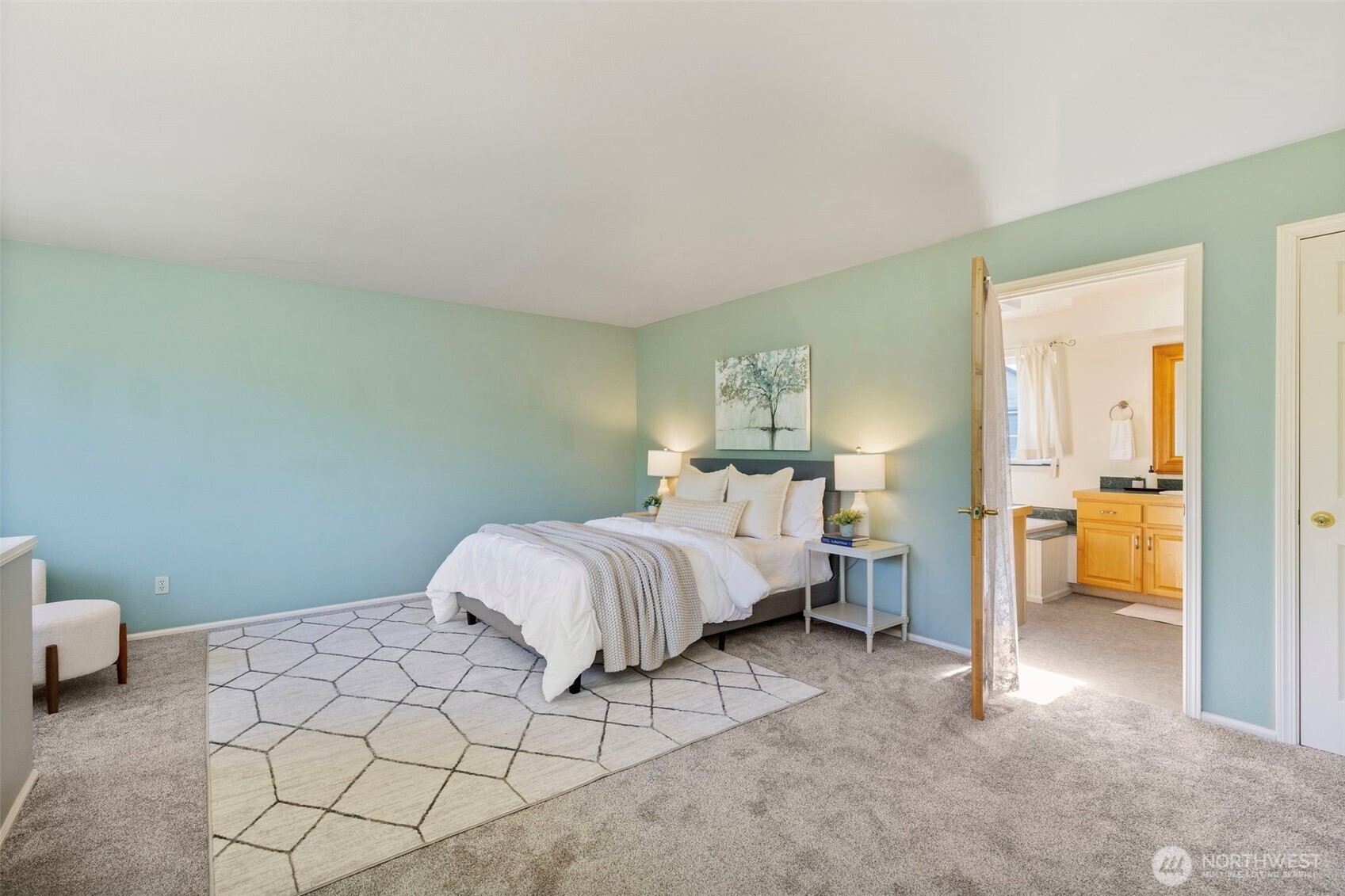 1757 Maple Street Port Townsend, WA 98368 - Photo 15 of 40 a spacious bedroom with a bed and a lamp