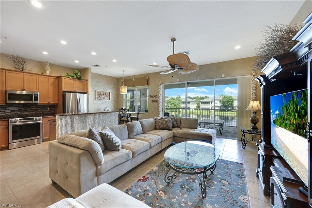 3530 Lansing Loop, Unit 202 Estero, FL 33928 - Photo 3 of 35 a living room with furniture and a large window