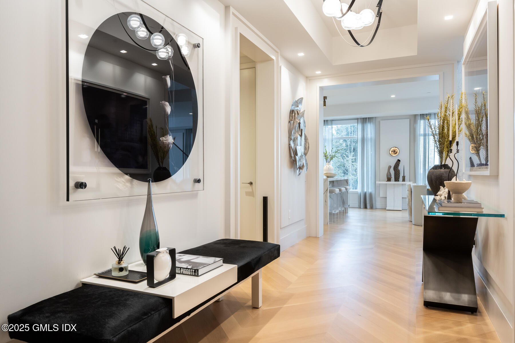 125 Field Point Road, Unit PH A6 Greenwich, CT 06830 - Photo 2 of 22 a hallway with a view of living room with furniture and a mirror