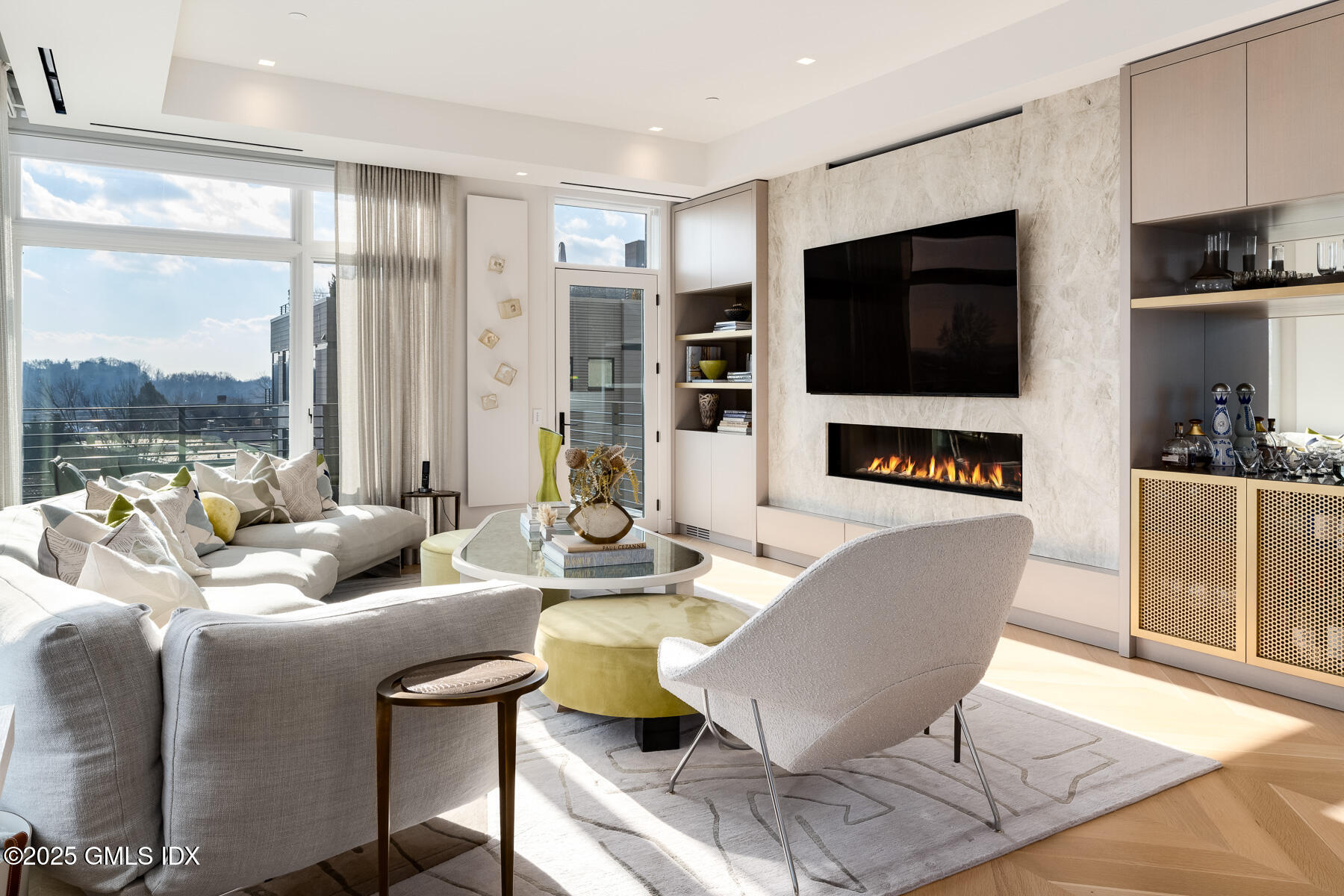 125 Field Point Road, Unit PH A6 Greenwich, CT 06830 - Photo 3 of 22 a living room with fireplace furniture and a flat screen tv
