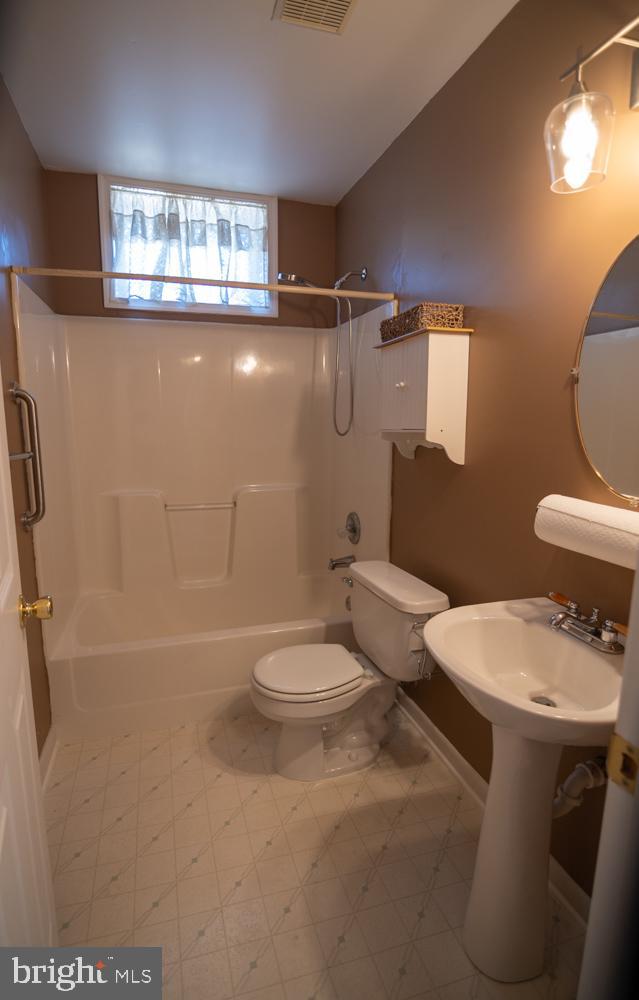 15900 Bald Eagle School Road Brandywine, MD 20613 - Photo 20 of 33 a white toilet sitting next to a bathroom sink and a tub