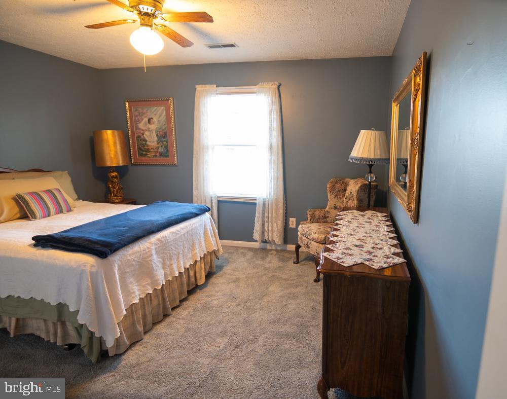 15900 Bald Eagle School Road Brandywine, MD 20613 - Photo 27 of 33 a bedroom with a bed and a chandelier