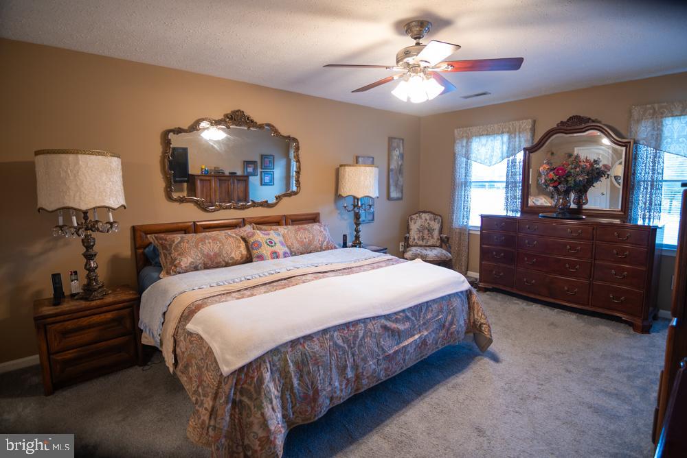 15900 Bald Eagle School Road Brandywine, MD 20613 - Photo 31 of 33 a bedroom with a bed a chandelier and dresser