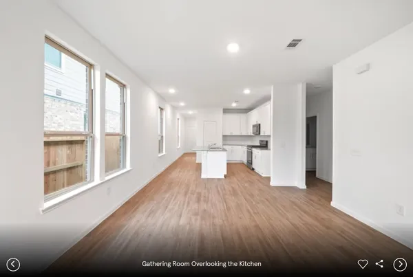 a view of kitchen with wooden floor and electronic appliances