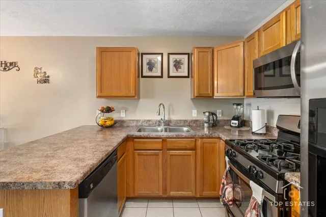 a kitchen with a sink stove top oven and cabinets