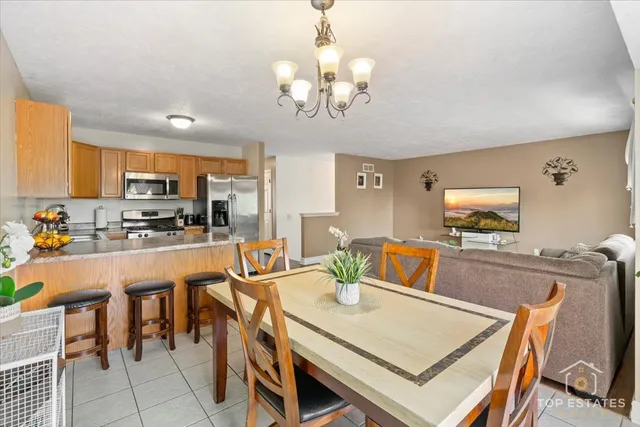 a view of a dining room with furniture and a chandelier