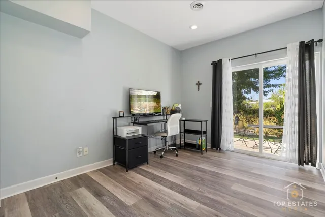 a view of a workspace with furniture and a window