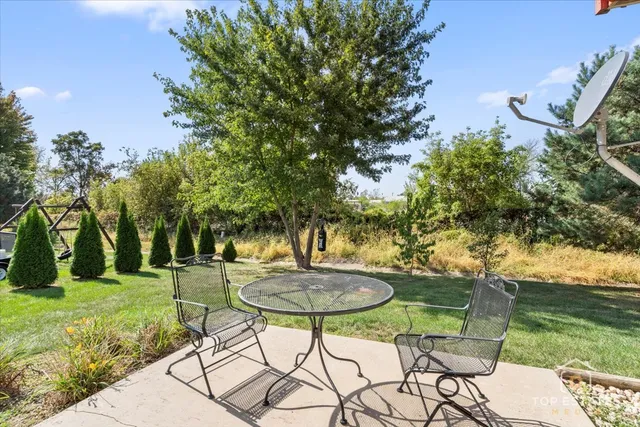 a view of a table and chairs in the garden