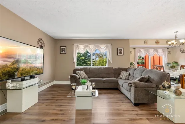 a living room with furniture and a flat screen tv