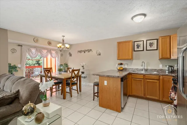 a open kitchen with stainless steel appliances granite countertop a sink and cabinets