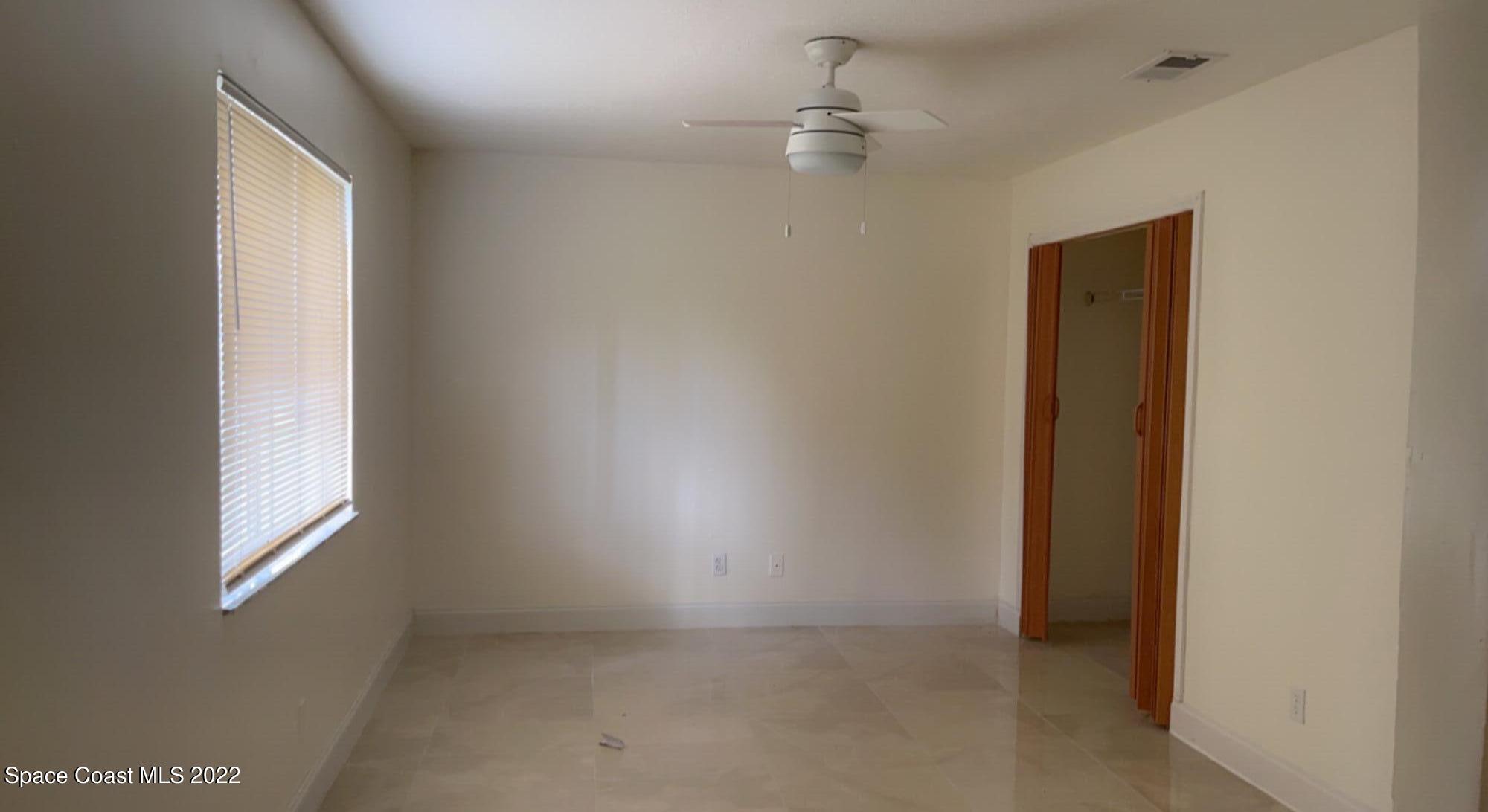 219 Eldron Boulevard Southeast Palm Bay, FL 32909 - Photo 2 of 9 an empty room with windows and closet