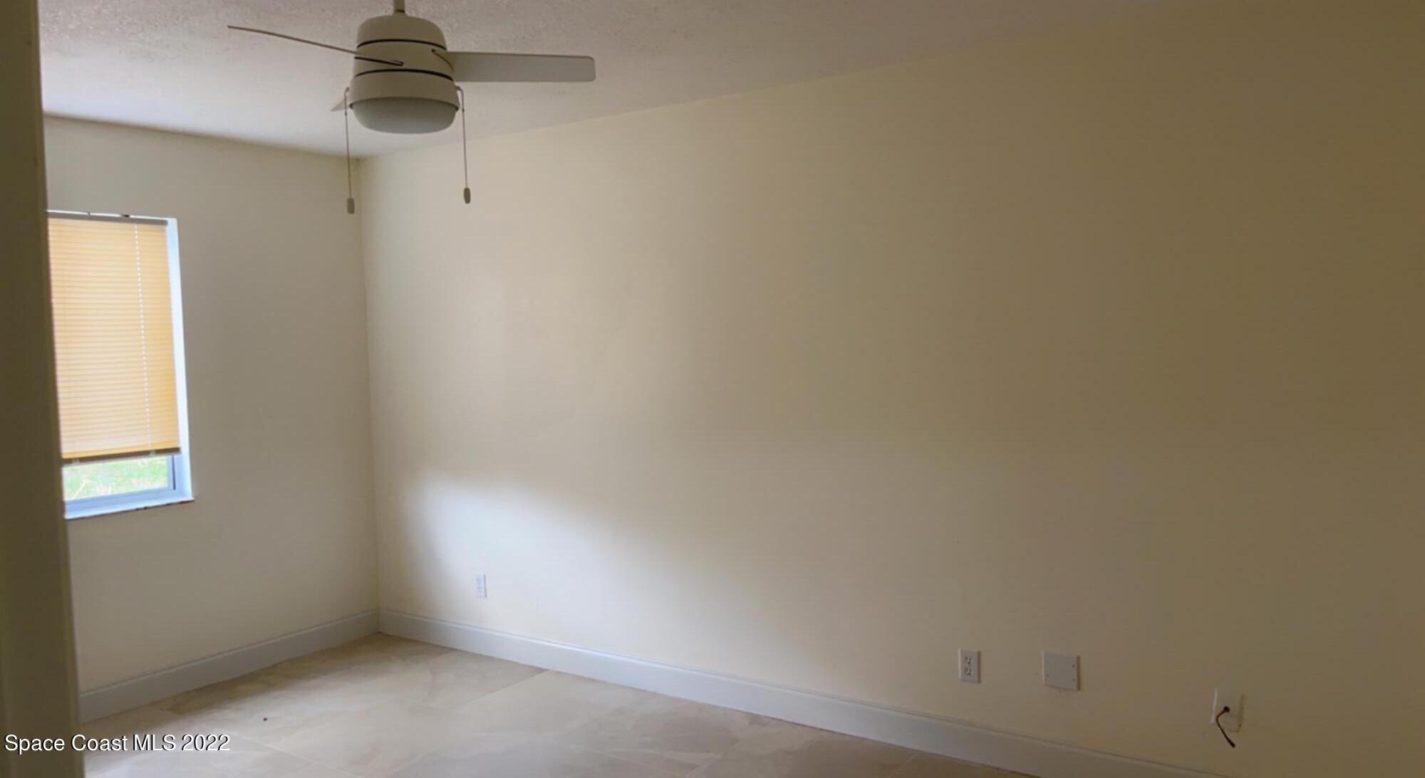 219 Eldron Boulevard Southeast Palm Bay, FL 32909 - Photo 8 of 9 an empty room with a window