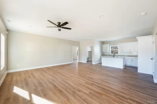 a big room with wooden floor and windows