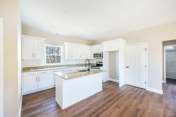 a kitchen with appliances cabinets and a sink