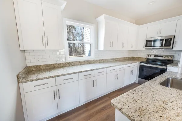 a kitchen with a granite countertop sink and a granite counter tops