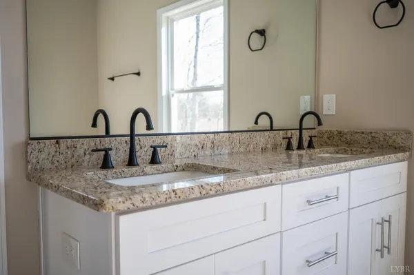 an empty room with wooden floor ceiling fan and windows