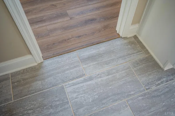 a view of an empty room and wooden floor