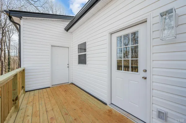a view of a house with a wooden deck