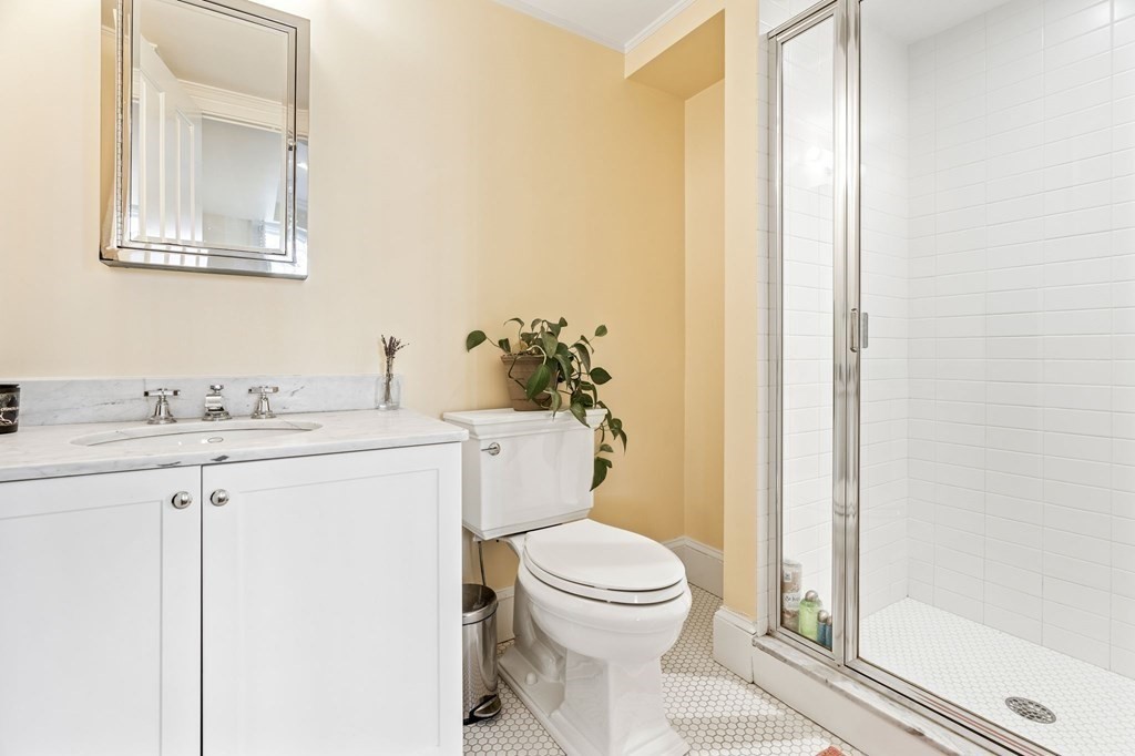 28 Rutland Square, Unit 1 Boston, MA 02118 - Photo 11 of 16 a bathroom with a granite countertop sink toilet and shower