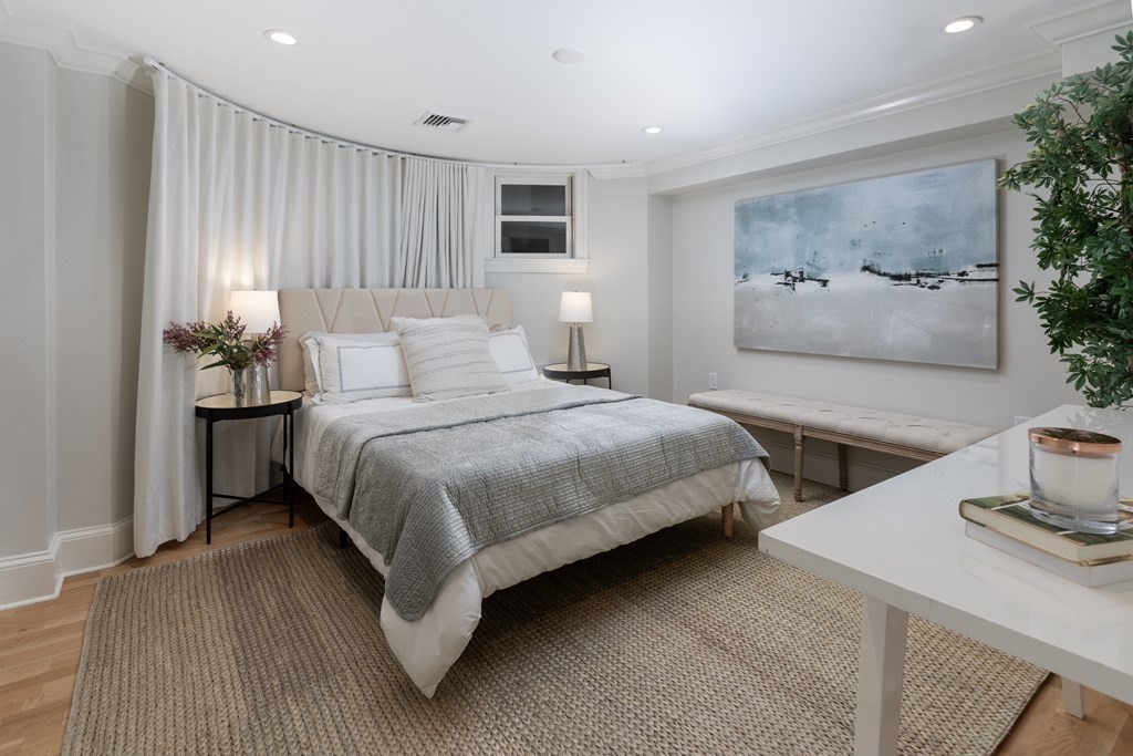 28 Rutland Square, Unit 1 Boston, MA 02118 - Photo 12 of 16 a bedroom with a bed and glass wall