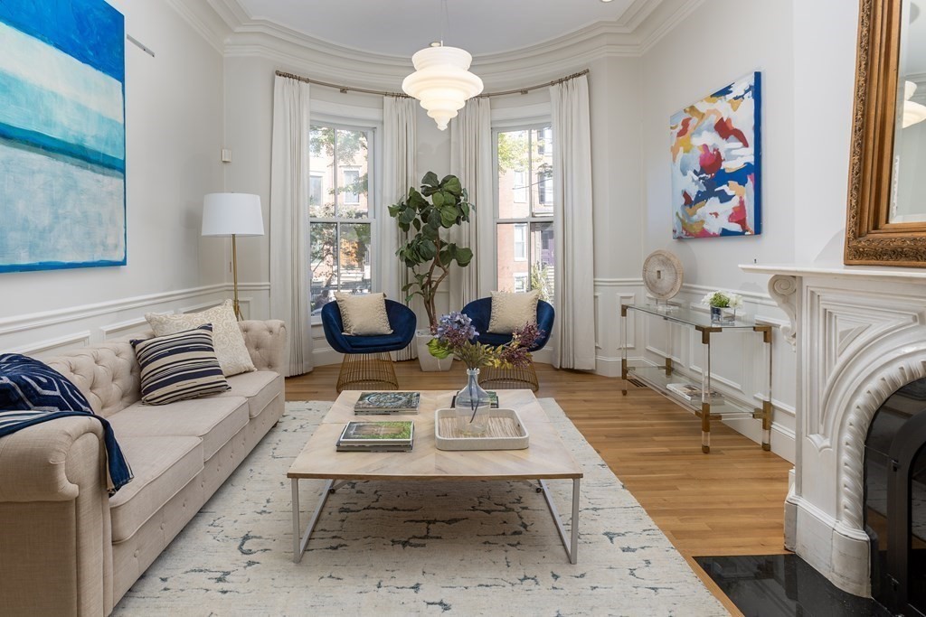 28 Rutland Square, Unit 1 Boston, MA 02118 - Photo 2 of 16 a living room with furniture a fireplace and a chandelier
