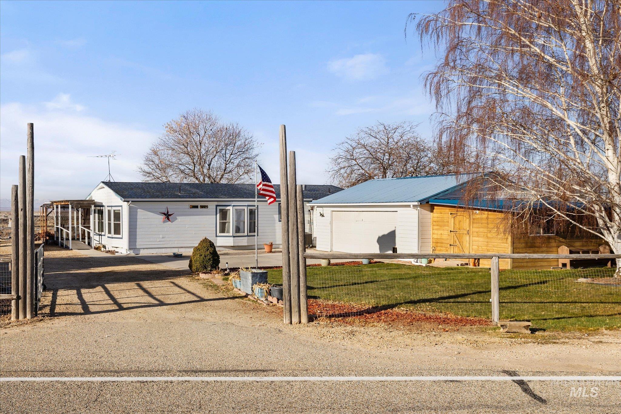 View of front of property with an outdoor structure and a garage