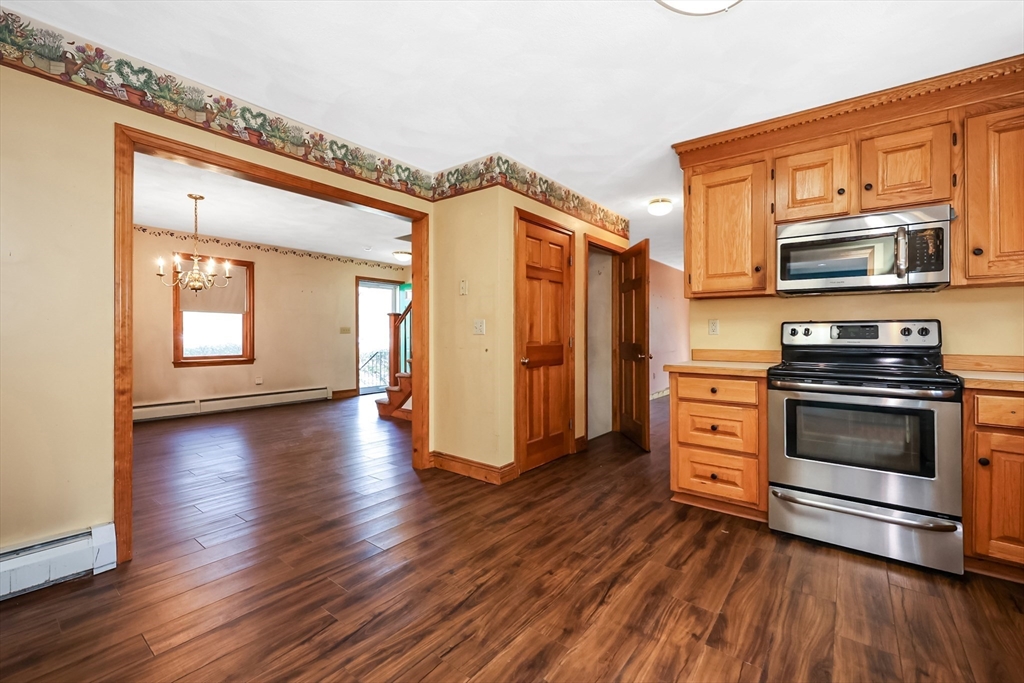 6 Ryan Road Townsend, MA 01474 - Photo 4 of 41 a kitchen with stainless steel appliances a stove and a wooden floors