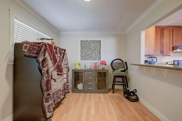 a view of a bedroom with a bed and wooden floor