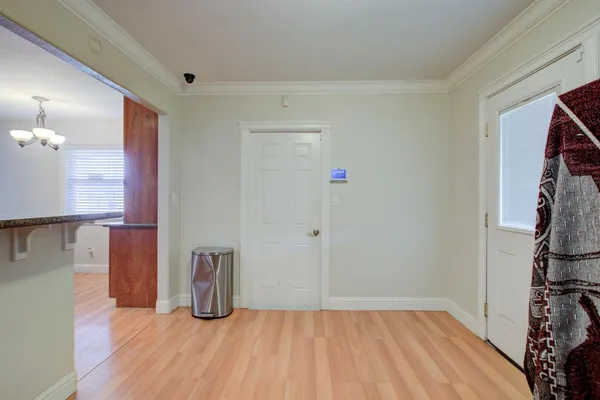 a view of empty room with wooden floor
