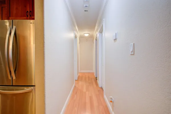 a view of a hallway with wooden floor