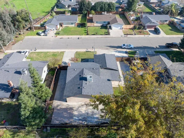 an aerial view of residential houses with outdoor space and parking