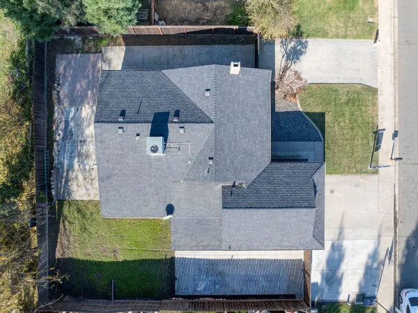 an aerial view of a house with a yard