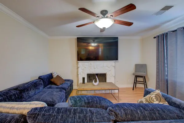 a living room with furniture a fireplace and a flat screen tv