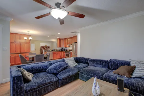 a living room with furniture and a ceiling fan