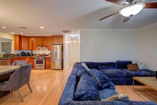 a living room with furniture and kitchen view